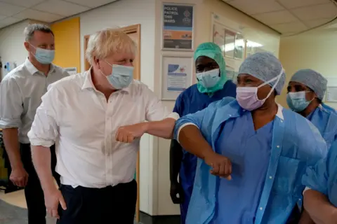 PA Media Prime Minister Boris Johnson meets members of staff during a visit to the South West London Orthopedic Center in Epsom on 26 August 2022.