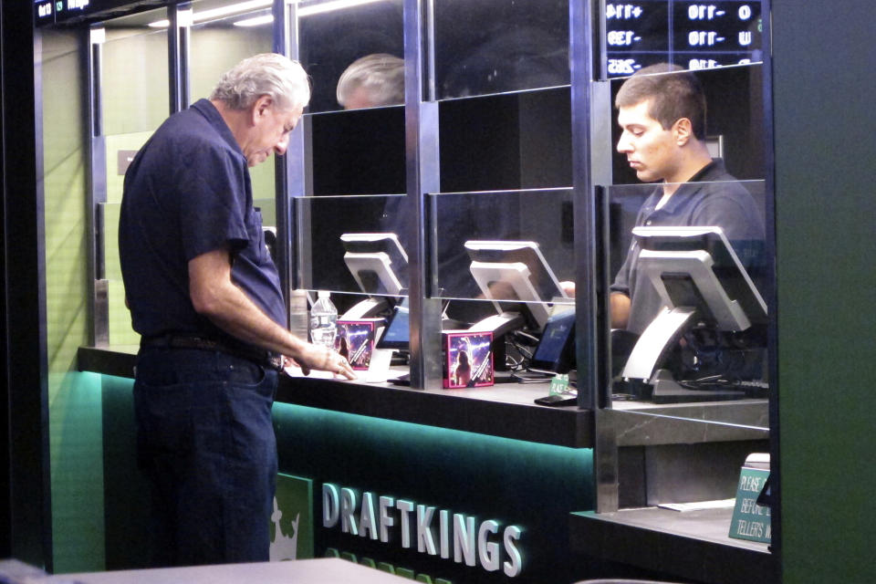 A man makes a bet at the DraftKings sportsbook in Atlantic City, NJ, Oct. 8, 2019. New Jersey regulators fined DraftKings $100,000 on June 17, 2024 for reporting incorrect sports betting information to the state, leading to a correction and resubmission. of New Jersey sports betting information for December 2023 and January and February 2024. (AP Photo/Wayne Parry)