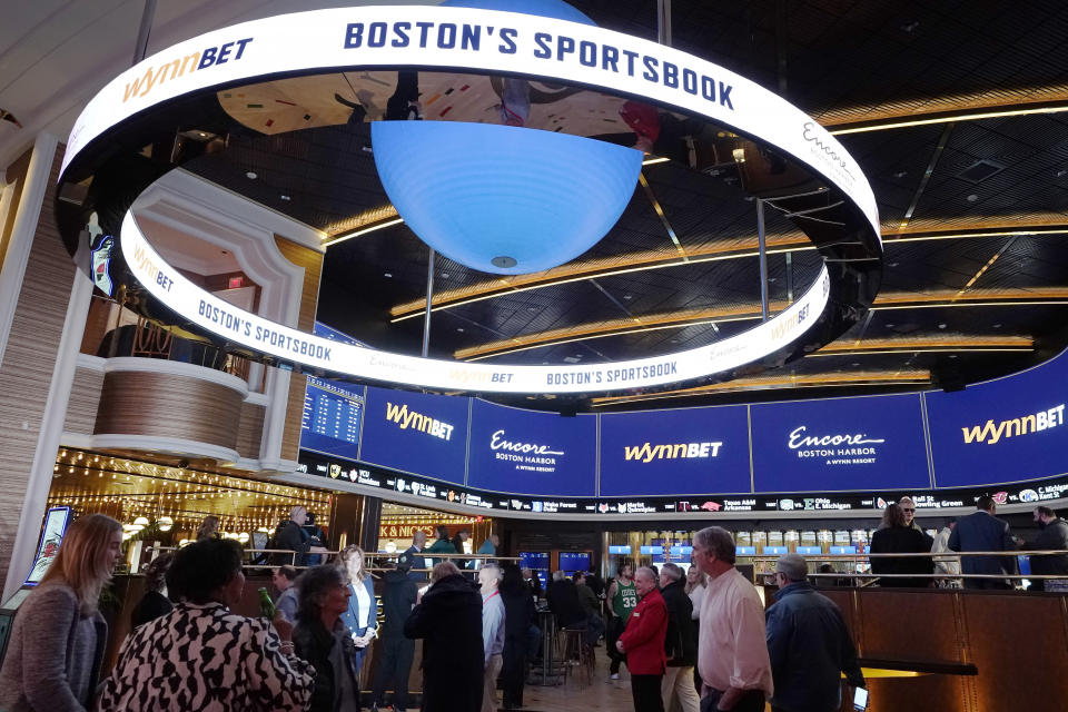 A sign, above, focuses on sports betting at the Encore Boston Harbor casino, Tuesday, Jan. 31, 2023, in Everett, Mass. Massachusetts sports fans who want to bet on their favorite teams finally get a chance when the state kicks off. Sports betting in casinos in the state begins on Tuesday, January 31, and online betting may follow in a few months. (AP Photo/Steven Senne)