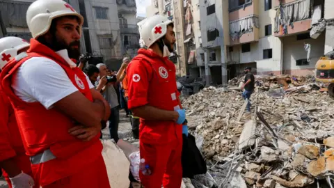 Reuters Medical staff are working at the site of Friday's Israeli strike, as search and rescue operations continued on Saturday